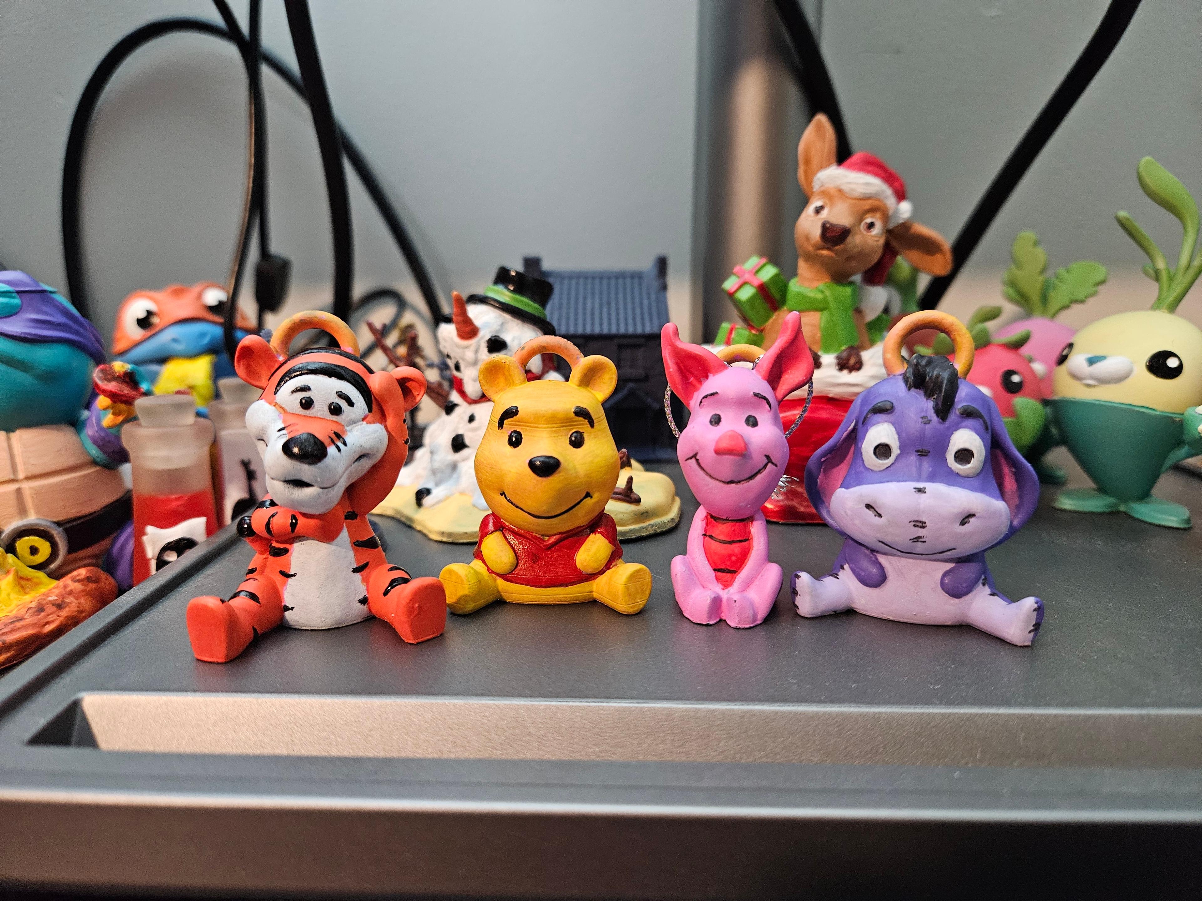 Picture of the whole gang sitting together on my computer desk. Tigger, Pooh, Piglet, Eeyore 